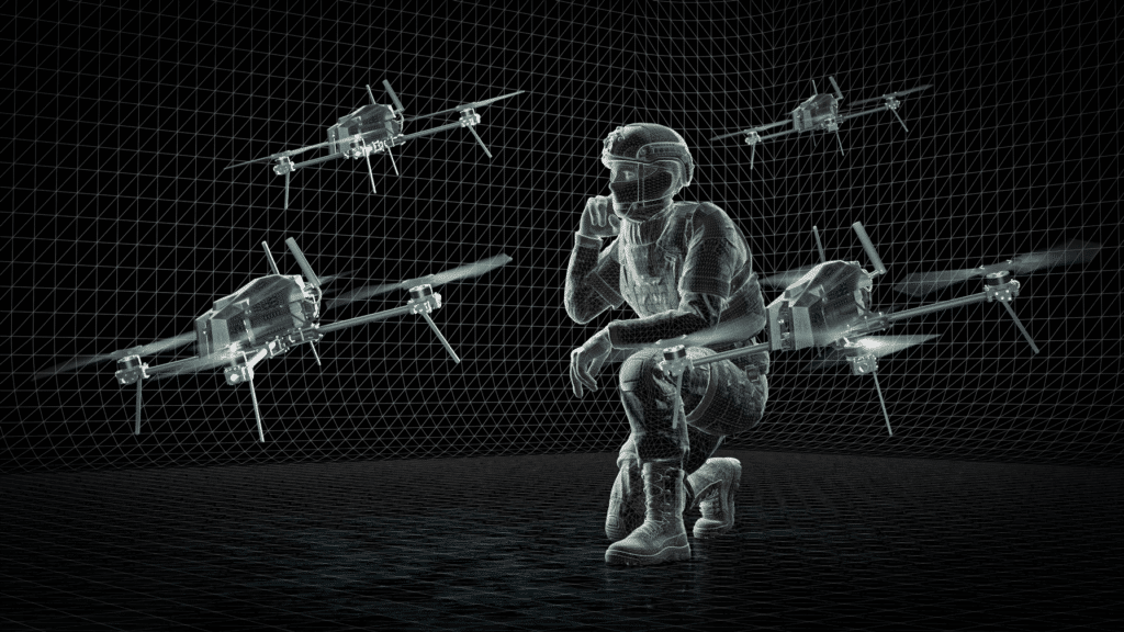 Soldier crouching while monitoring autonomous drones operating in formation, illustrating AI-driven aerial systems supporting military operations in contested environments.
